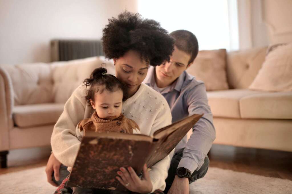 Father and mother read to their baby
