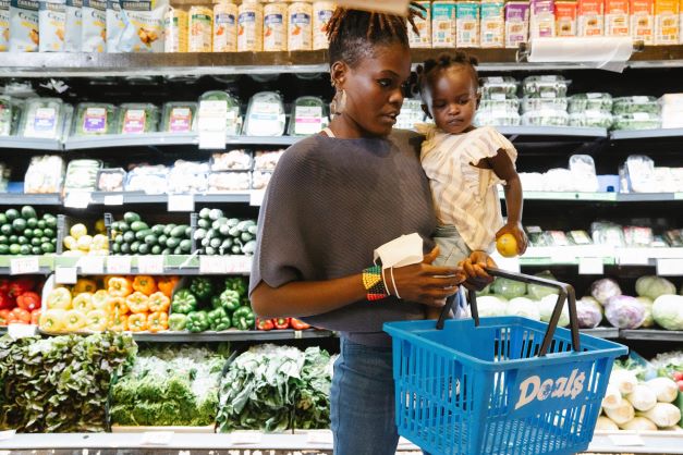 Children's misbehaviour in public; A mom is shopping in a supermarket with her baby
