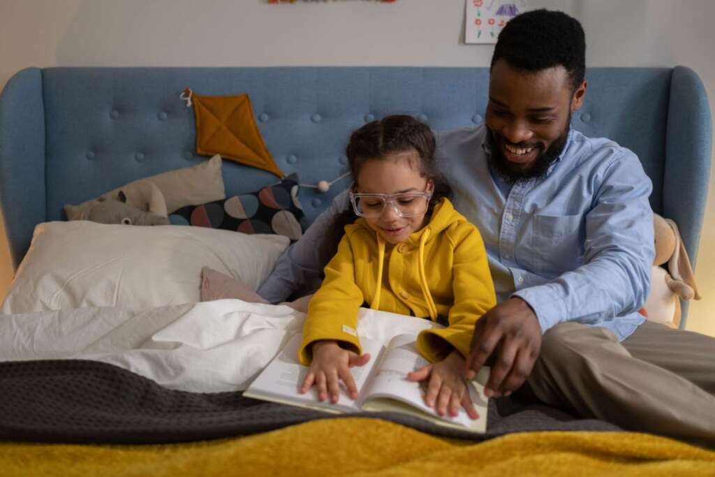 Father reading a book with his daughter; black children's books
