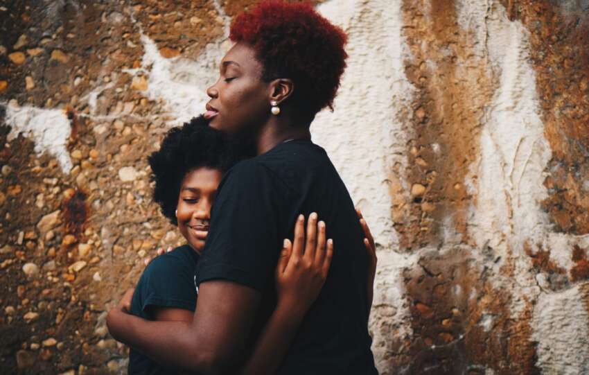 mother hugging teen child