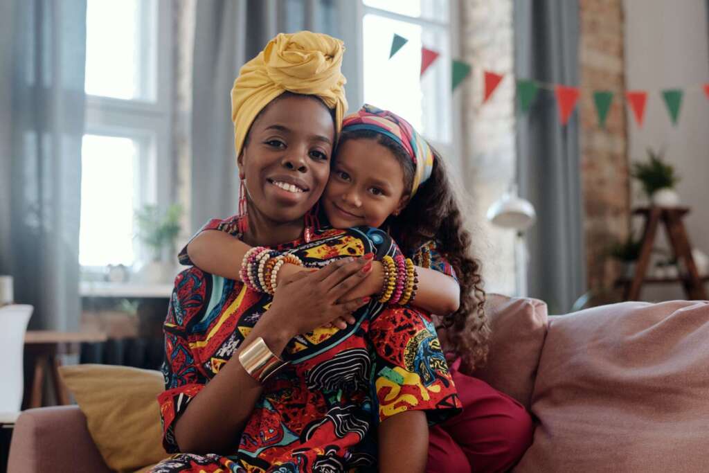 Mom and daughter hug; celebrating single mothers