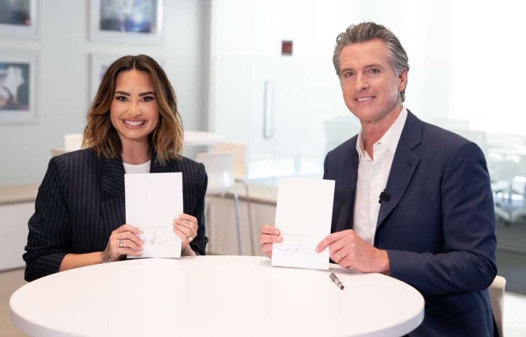 Gov. Gavin Newsom is with Demi Lovato as he signs child influencer bills.